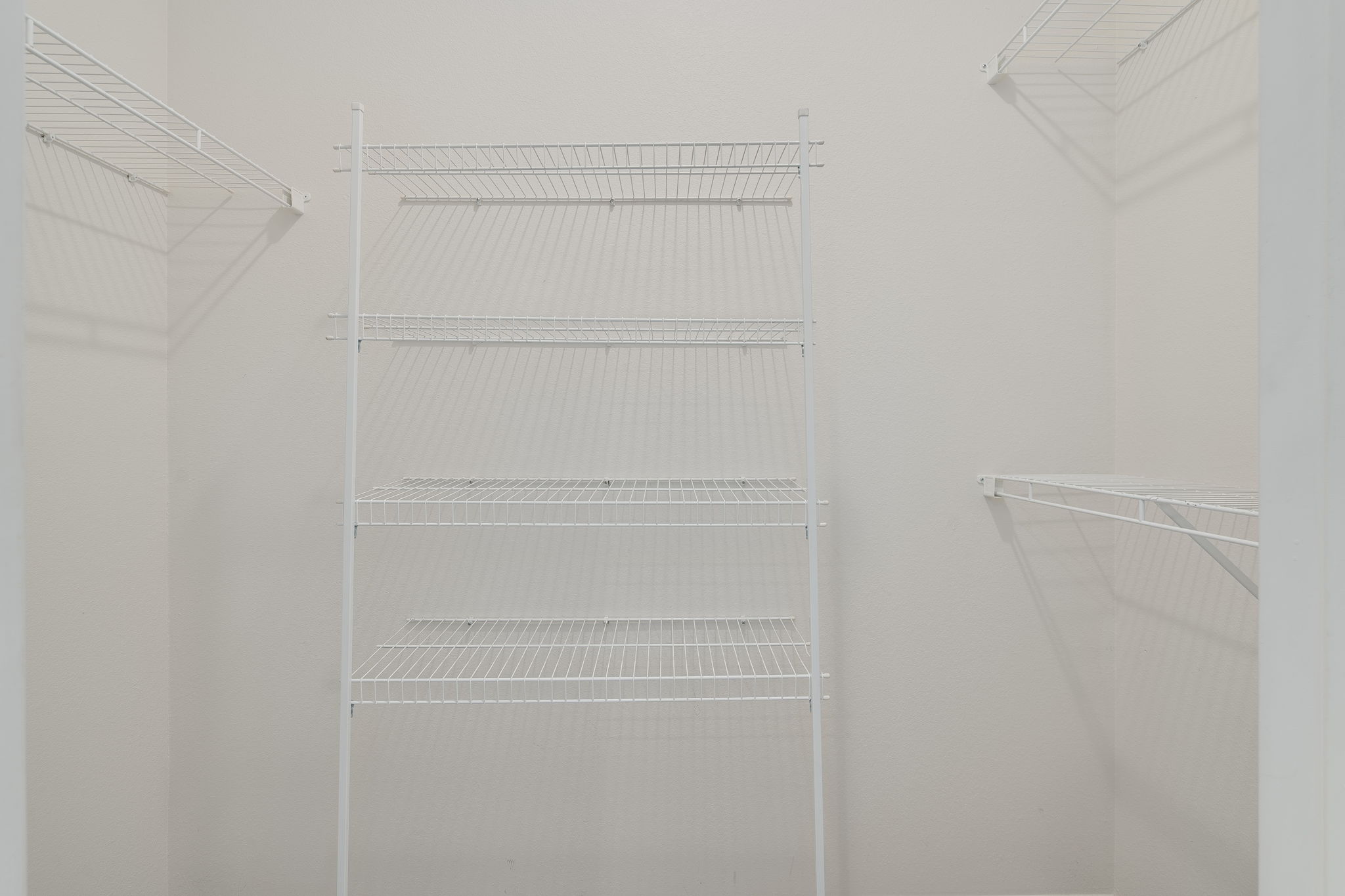 Empty white shelves in a room.